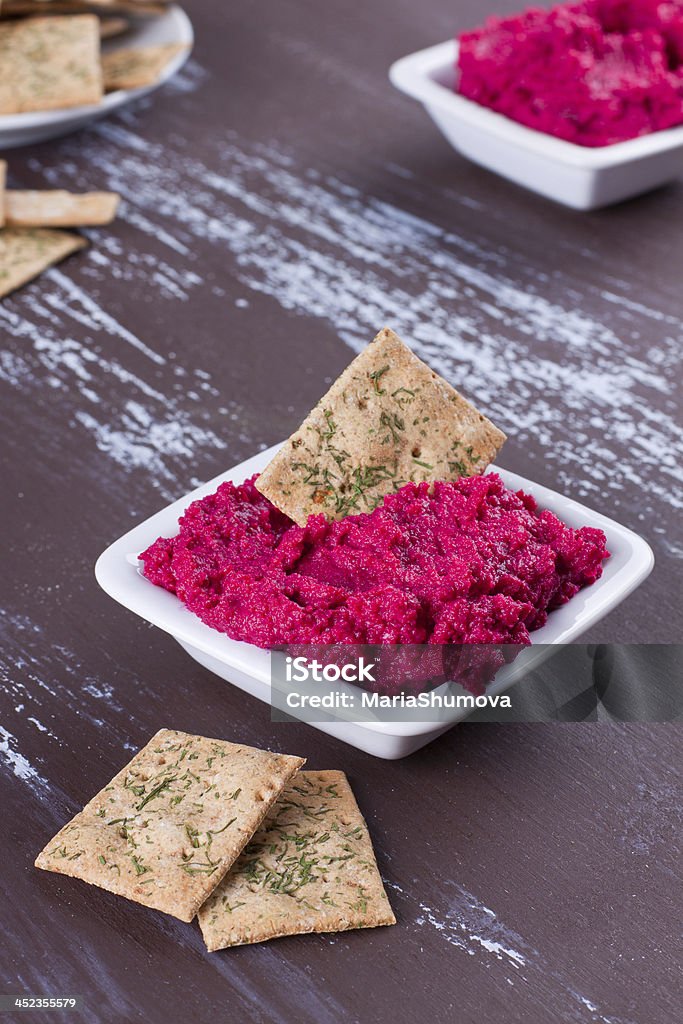 Portion of hummus Portion of beetroot hummus with crackers Cracker - Snack Stock Photo