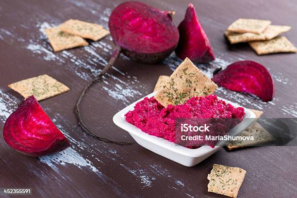 Dish Of Beetroot Hummus With Crackers On A Wooden Table Stock Photo - Download Image Now