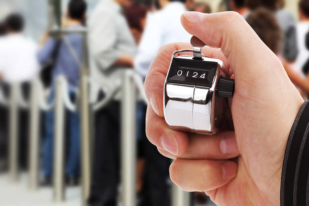 Counting people Hand held tally counter counting headcount of people in a queue door attendant photos stock pictures, royalty-free photos & images