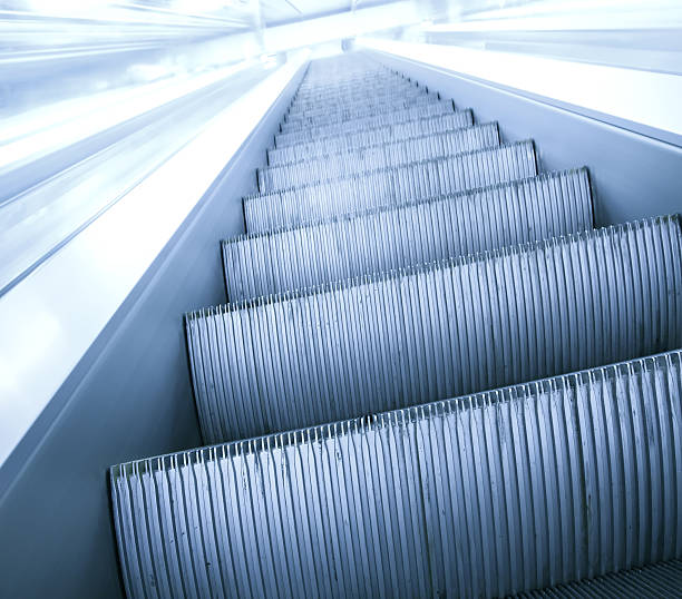 istock gray steps of escalator in business center 452362017