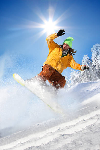 istock Snowboarder jumping against blue sky 452365845