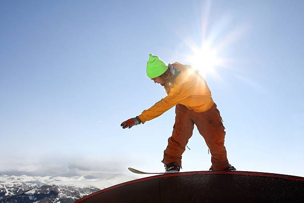 istock Snowboarder jumping against blue sky 452365911