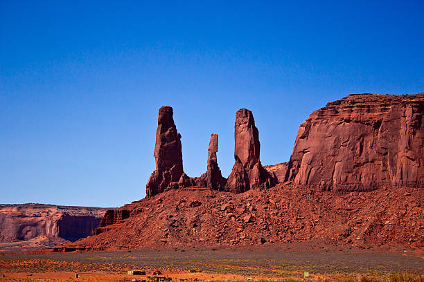 The Three Sisters, Monument Valley National Park, Arizona the Three Sisters, a peculiar rock formation in the Monument Valley National Park hystoric stock pictures, royalty-free photos & images