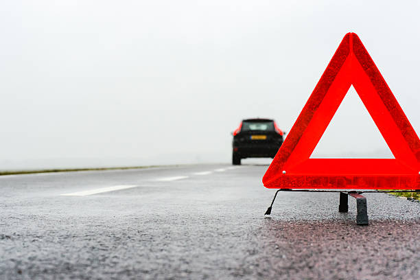istock car with a breakdown in the rain and fog 452369115