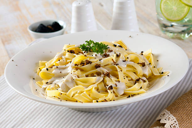 Truffle Pasta Vegetarian pasta with cream sauce and truffle mushrooms. tartuffo stock pictures, royalty-free photos & images