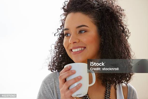 Pretty Young Lady With Coffee And Looking Away Smiling Stock Photo - Download Image Now