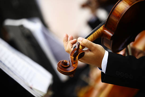 istock A man it a suit reading music playing a violin 452377797