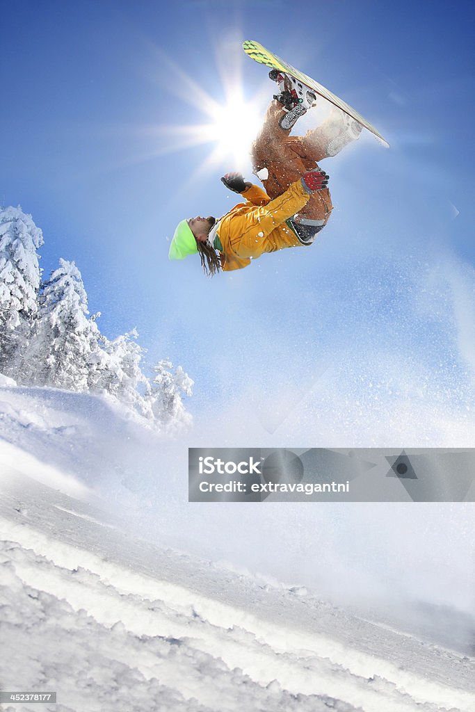 Snowboarder jumping against blue sky Snowboarder jumping against blue sky in high mountain Snowboard Stock Photo