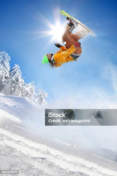 Snowboarder Jumping Against Blue Sky Stock Photo - Download Image Now - Snowboard, Colorado, Skiing