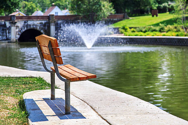 Park bench overlooking pond stock photo