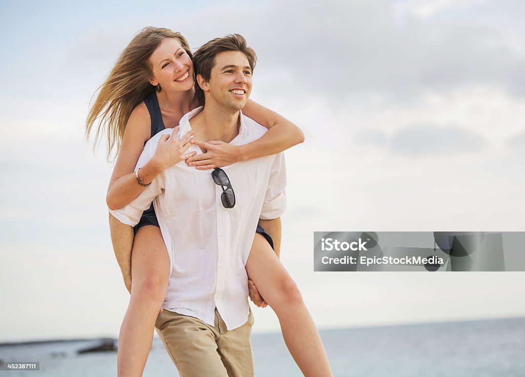 Romantic happy couple on the beach at sunset Romantic happy couple on the beach at sunset, man and woman in love Adult Stock Photo