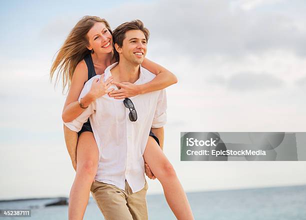 Romantic Happy Couple On The Beach At Sunset Stock Photo - Download Image Now - Adult, Affectionate, Beach