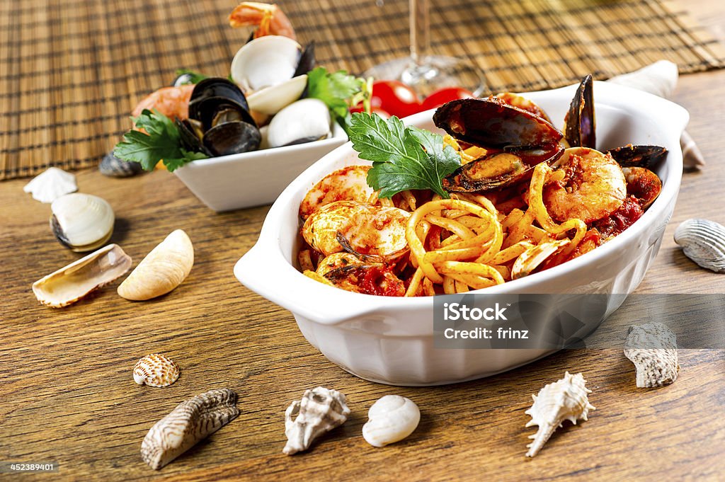 Spaghetti with mussels and tomato sauce Spaghetti with mussels and tomato sauce on wooden table Backgrounds Stock Photo