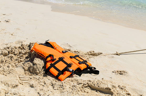 istock Orange life jacket on the beach 452405029
