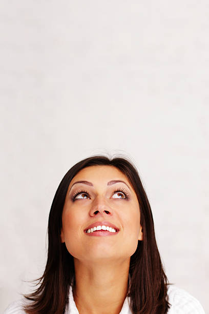 istock woman looking up at copyspace 452405479