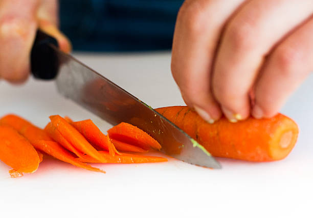 istock Chef cutting carrot for to make a green salad 452405993
