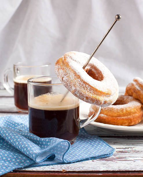 istock Cup of coffee and donuts 452419053