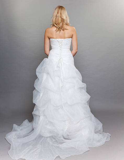 istock blonde bride white long wedding dress back view on gray 452456959