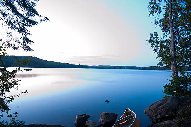 istock Canoe on Lake Edge at Dusk 452462093