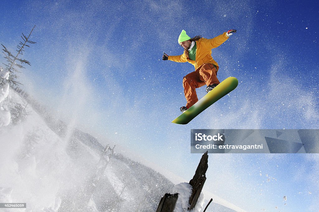 Snowboarder jumping against blue sky Snowboarder jumping against blue sky in high mountain Activity Stock Photo