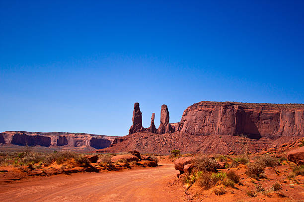 Three Sisters, Monument Valley National Park, Arizona the Three Sisters, a peculiar rock formation in the Monument Valley National Park hystoric stock pictures, royalty-free photos & images