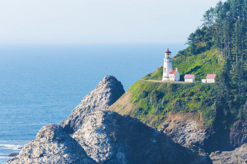 A lighthouse on a cliff along the Oregon Coast, USA.