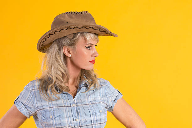 istock woman holding a cowboy hat 452478273
