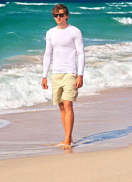 istock Handsome Man walking on the Beach Seaside sand 452491247