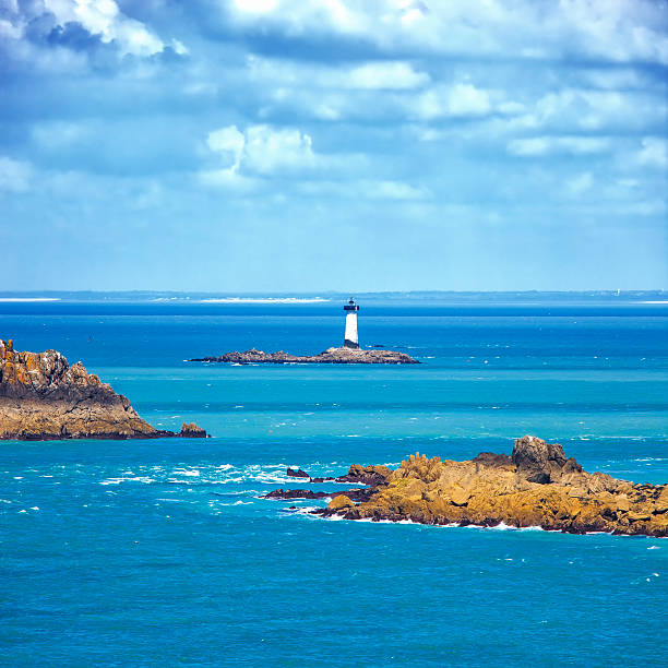 Brittany ocean panorama, island lighthouse Point du Grouin. Cancale, United Kingdom Brittany ocean panorama, Landes island and lighthouse Point du Grouin. Mont Saint Michel bay entrance. Cancale, France cancale photos stock pictures, royalty-free photos & images