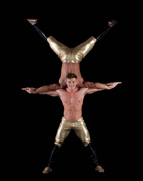 istock Pair of young muscular half-naked acrobats 452498583