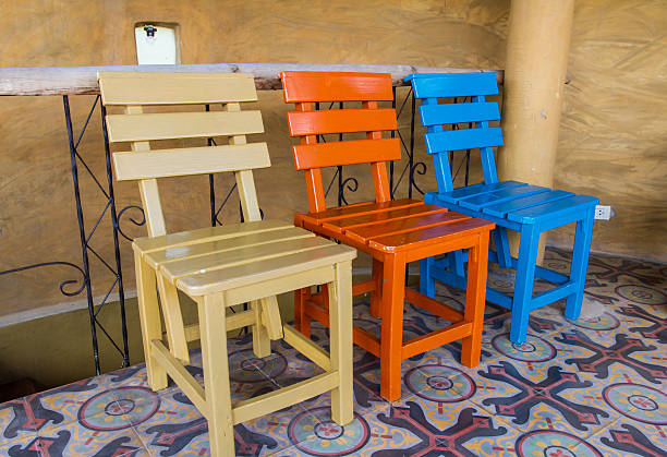 Three chairs Three chairs in brown room. triumvirate stock pictures, royalty-free photos & images