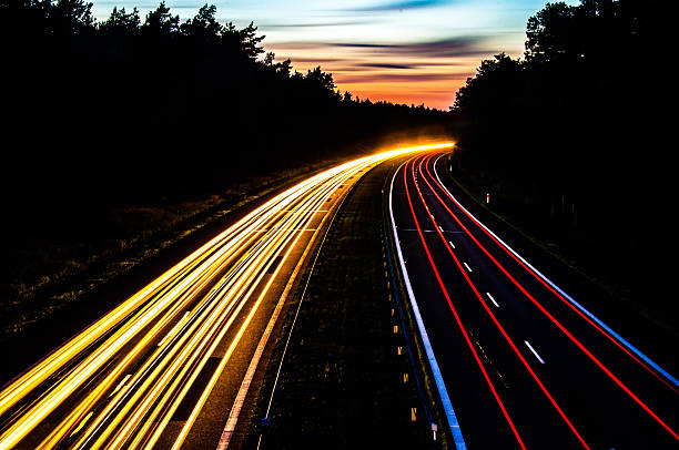 istock Car lights on a highway at night 452503459