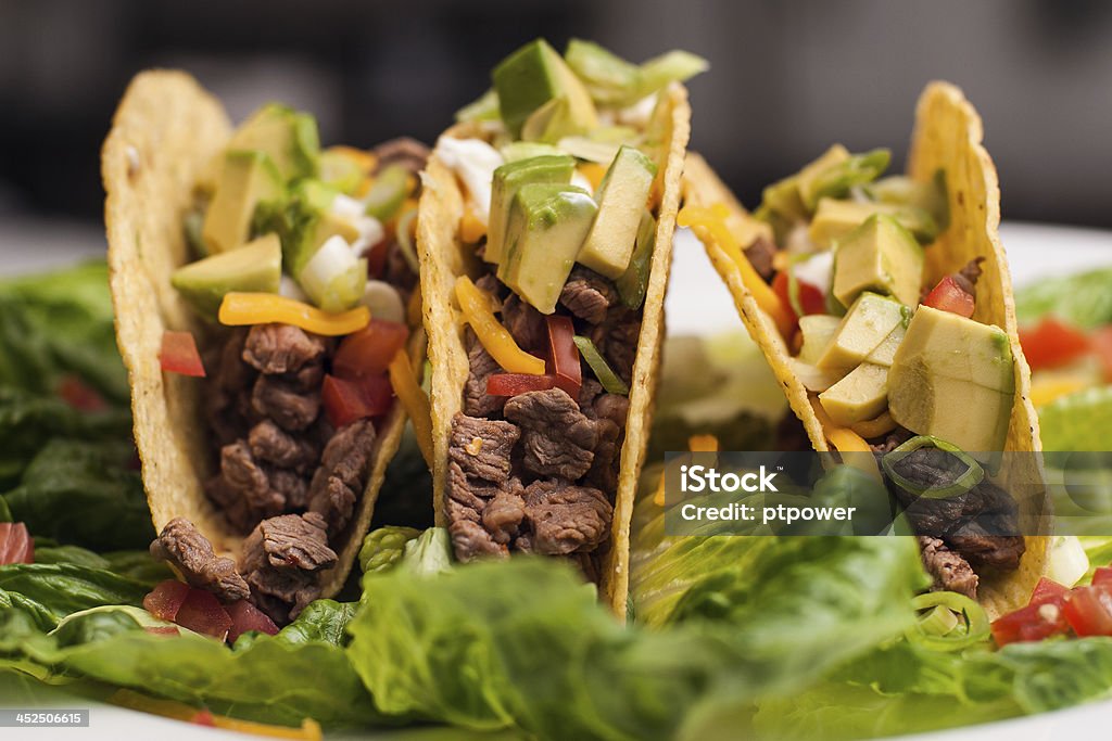 Trio of roast beef hard-shell tacos Trio of roast beef hard-shell tacos nested in lettuce Taco Stock Photo