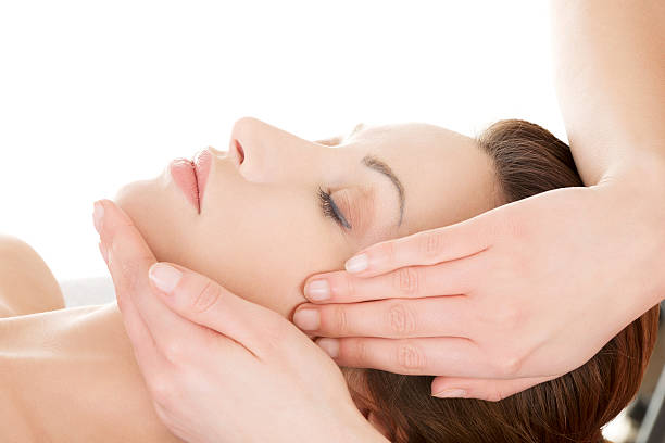 istock Young beautiful lying on a table at spa salon. 452507943
