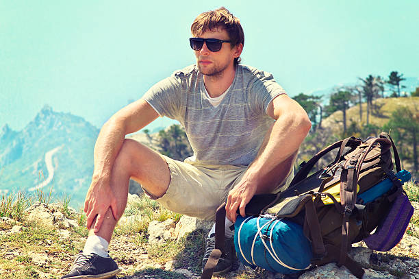 istock Young Man Traveler with backpack relaxing on Mountain summit 452511433
