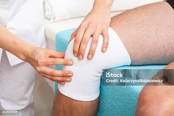 Examination Of Knee Stock Photo - Download Image Now - Adhesive Bandage, Bandage, Doctor