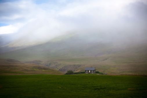 Icelandic Landscape: Lonely House in Foggy Mountains. Horizontal shot