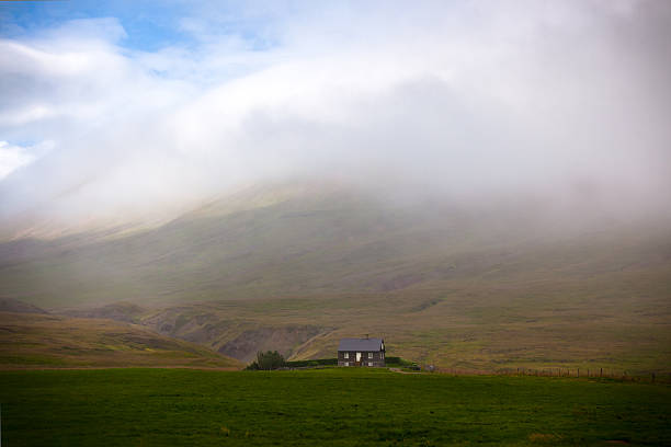 Icelandic Landscape: Lonely House in Foggy Mountains. Horizontal shot