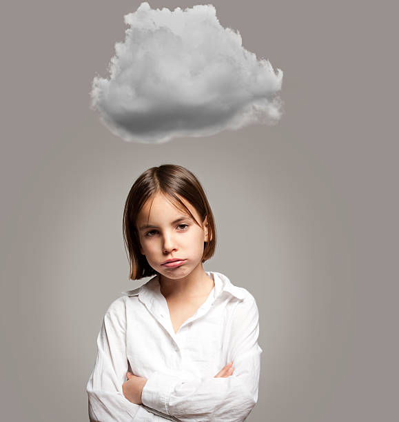istock little girl with a cloud over her head 452519693