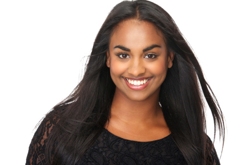 Close up portrait of a beautiful young woman with long flowing hair, smiling on isolated white background