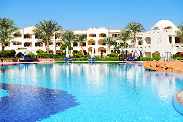 istock Sunbeds near swimming pool at luxury hotel 452533621