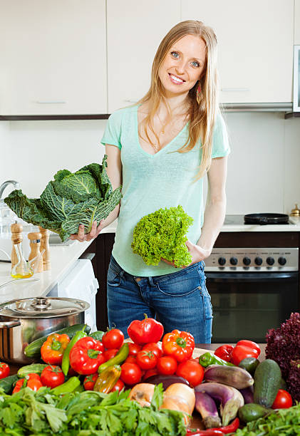 istock Blonde beautiful housewife  with fresh vegetables 452535101