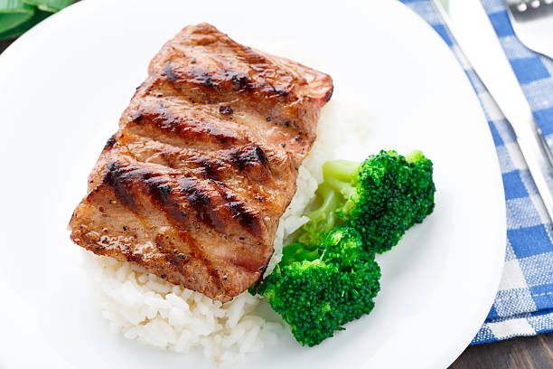 istock Grilled ribs with rice and broccoli 452538185
