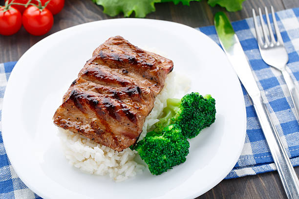 istock Grilled ribs with rice and broccoli 452538199