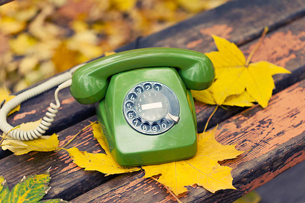 istock green vintage phone on bench in autumn park 452541075