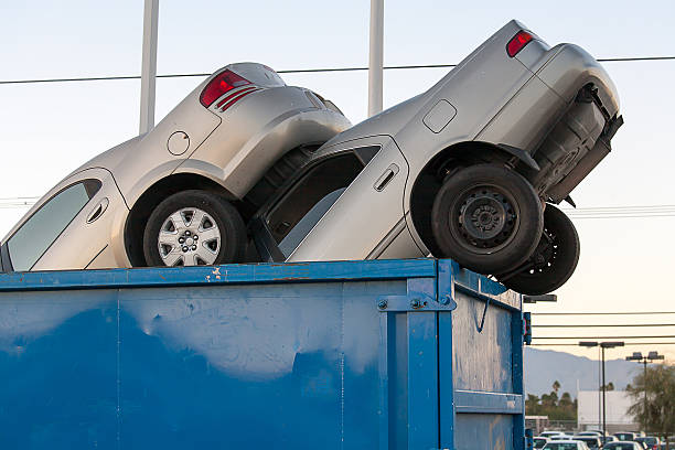 Junk cars in dumpster cash for clunkers stock photo