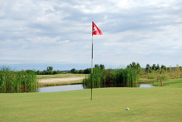 istock golf course with red flag and ball 452541153