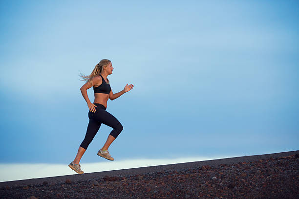 istock Athletic woman running jogging outside 452542175