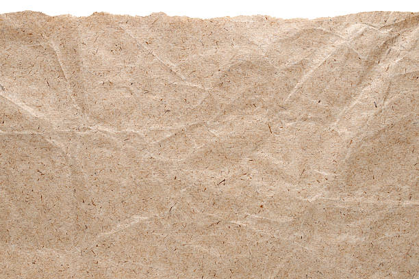 Kraft paper background with torn edge Kraft paper background with torn edge isolated on white torn brown paper stock pictures, royalty-free photos & images
