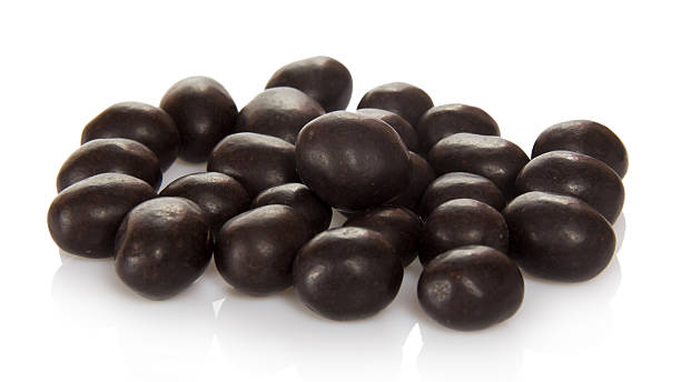 istock Sweet peanuts in chocolate isolated on white. 452546271